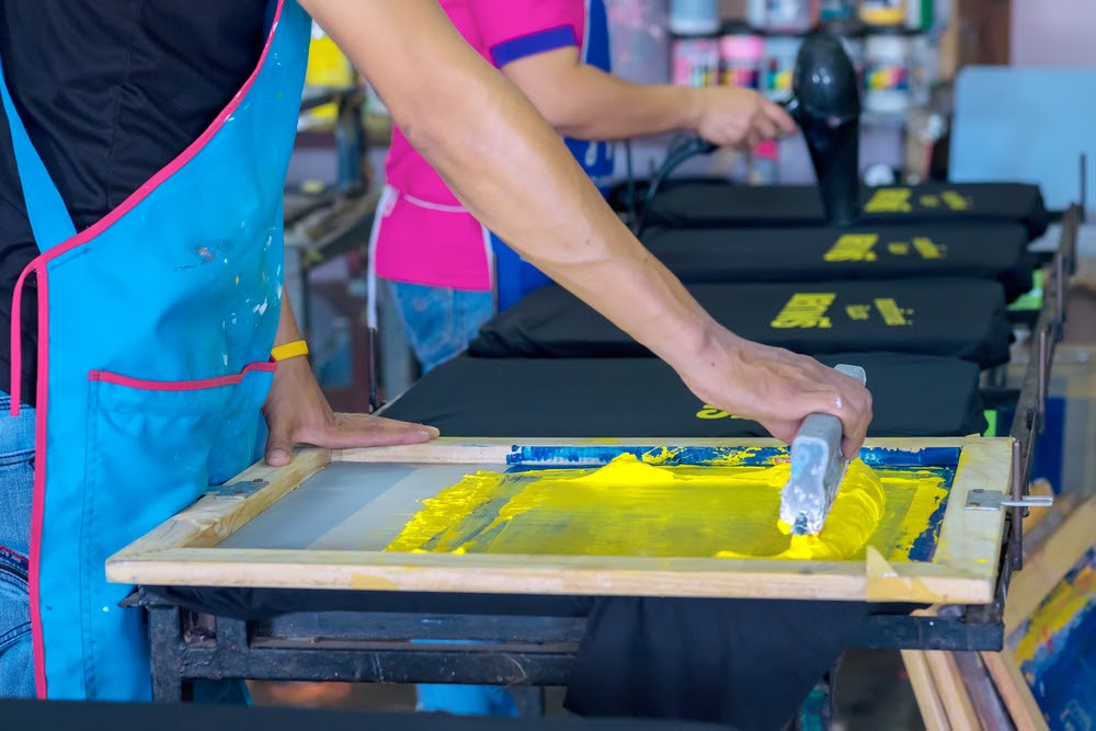 man doing screen printing